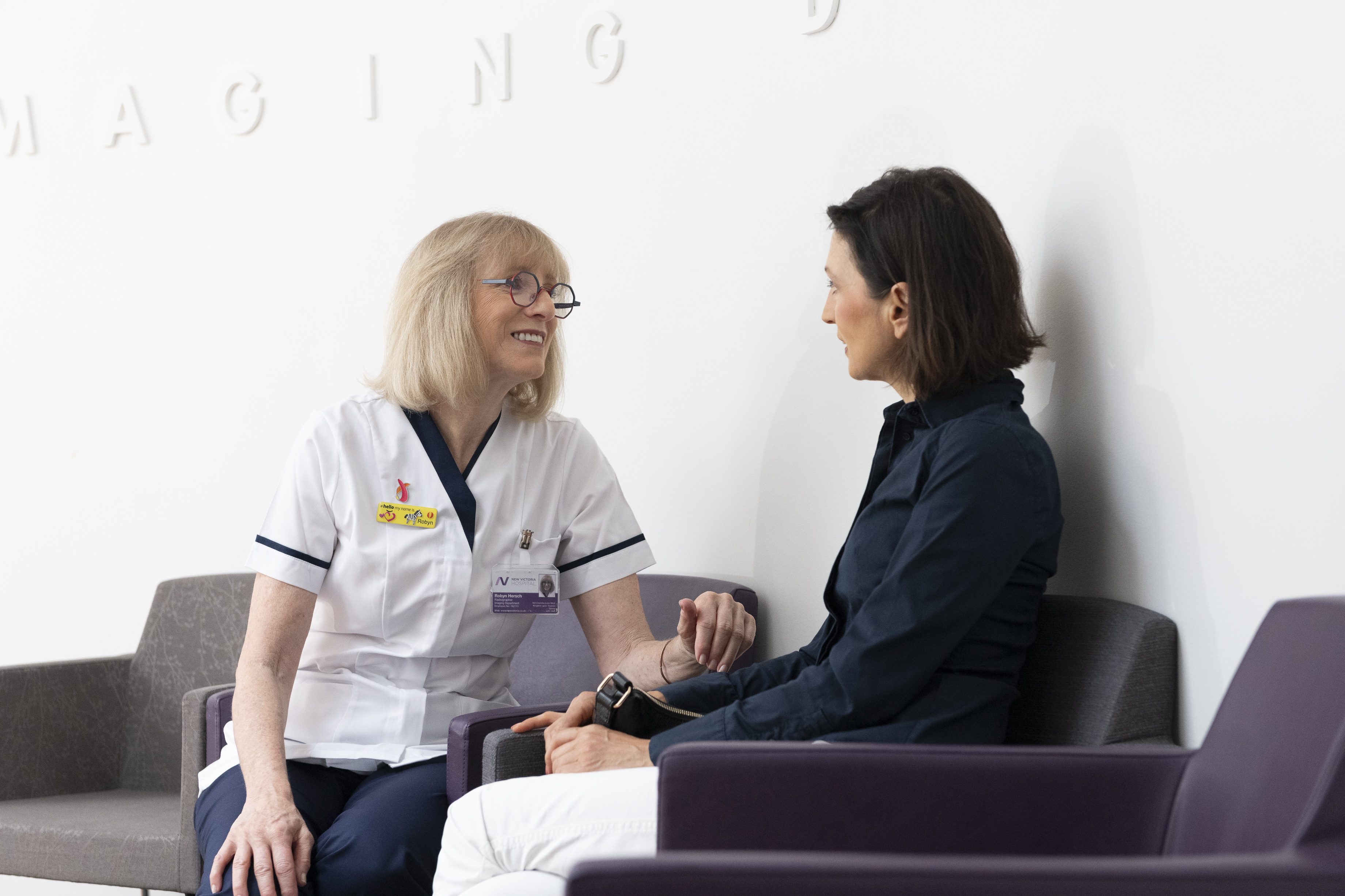 women in a waiting room with a nurse