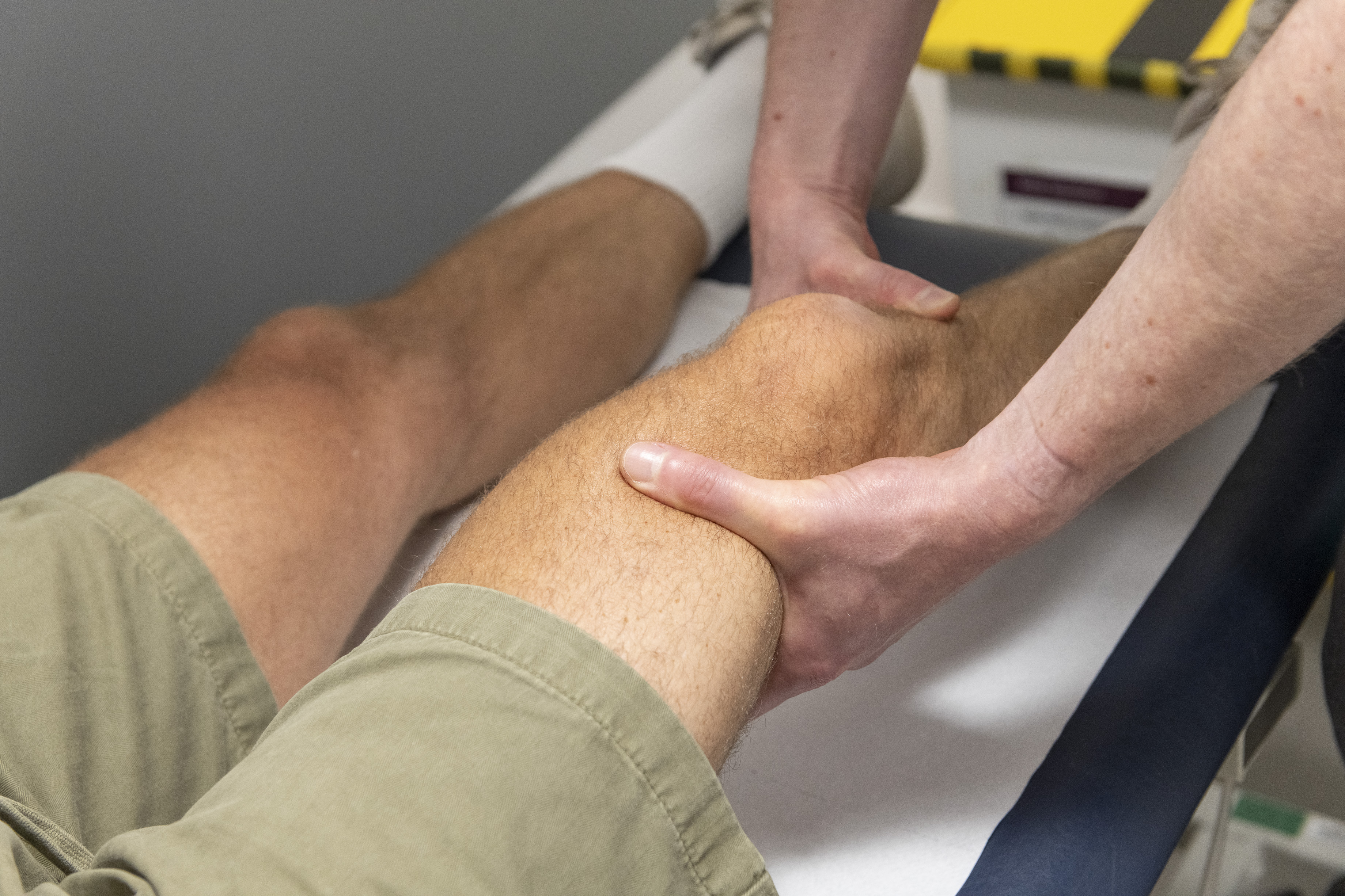 Mr Simon Hislop looking at a patient's knee