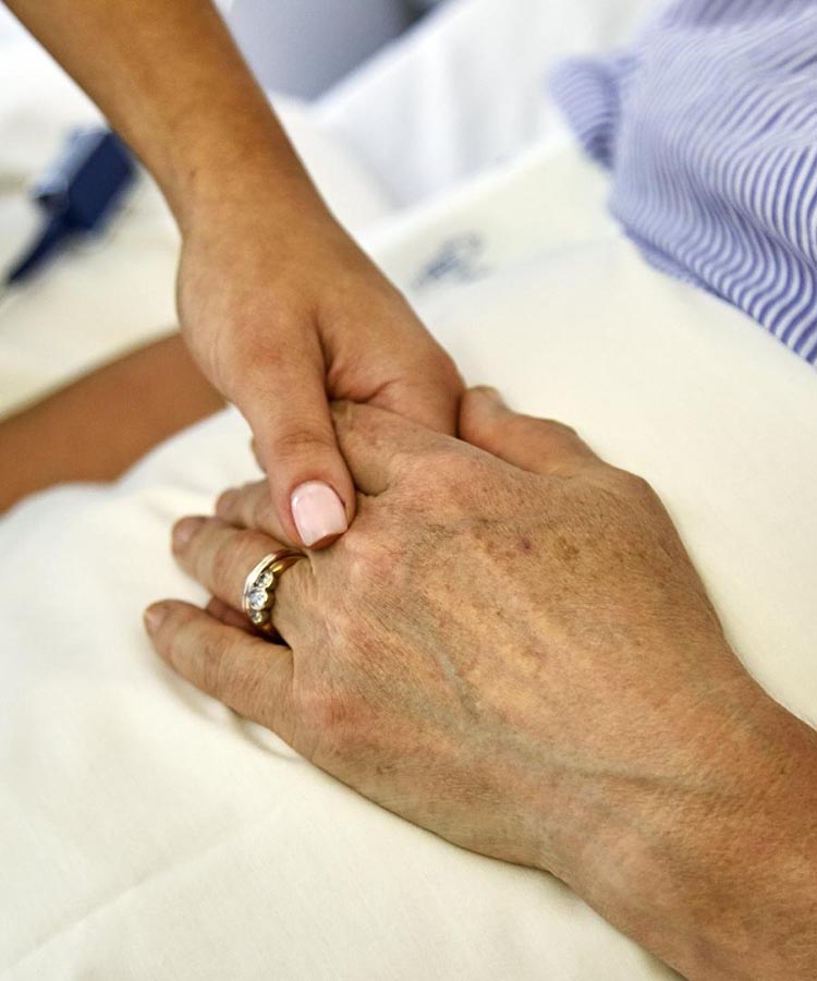 Holding a patient's hand