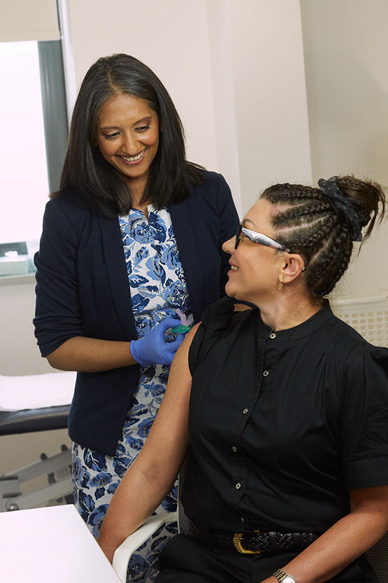 Dr Ritu Malaiya with a female patient